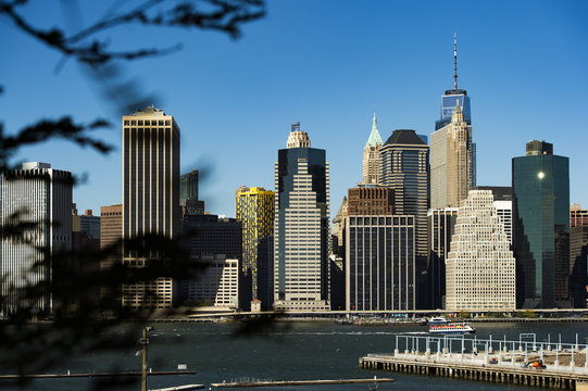 Amazing view of the Manhattan skyline seen from the Brooklyn Bridge Park. Sunny day of October in New York. USA.