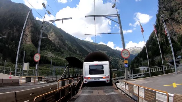 Recreational vehicle boarding a car shuttle train on a mountain in Switzerland