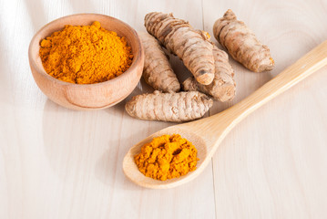 Turmeric powder in the wooden bowl (Curcuma longa)