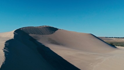 Fototapeta na wymiar aerial picture a sand dune peak in a beautiful desert environment