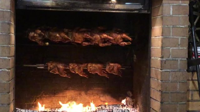 Roasting chickens in a large fireplace in a home in Switzerland