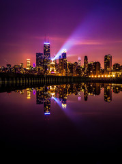 Beautiful long exposure Chicago night skyline photo with building lights at sunset with pink purple...