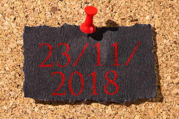 Cork panel. Red thumbtack, black paper: Black Friday concept. Text: 23/11/2018