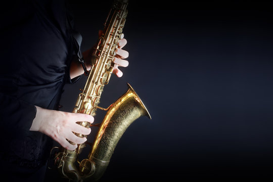 Saxophone Player Saxophonist playing jazz music. Sax player hands