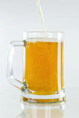 Beer is poured in a glass