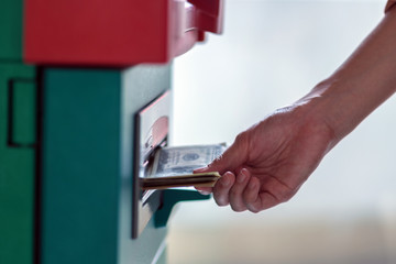 Closeup woman holding the wallet and withdrawing the cash via ATM, business Automatic Teller Machine concept