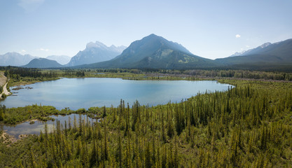 Aerial panoramic view of Vermilion Lakes during a vibrant summer day. Taken in Banff, Alberta, Canada.