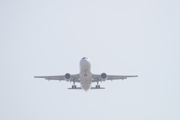 Airplane flying high departing from the airport