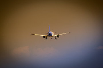 Big airplane flying on crazy dark sky