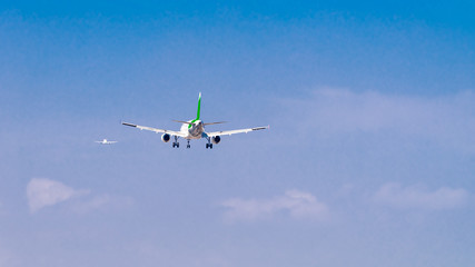 Two airplanes one landing and another  taking off