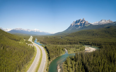 Beautiful aerial panoramic landscape view of a highway in Canadian Rockies during a vibrant sunny...