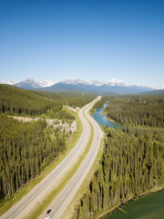 Beautiful aerial landscape view of a highway in Canadian Rockies during a vibrant sunny day. Taken...