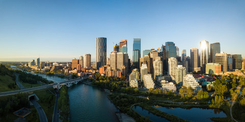 Fototapeta premium Aerial panoramic view of a beautiful modern cityscape during a vibrant sunny sunrise. Taken in Calgary Downtown, Alberta, Canada.