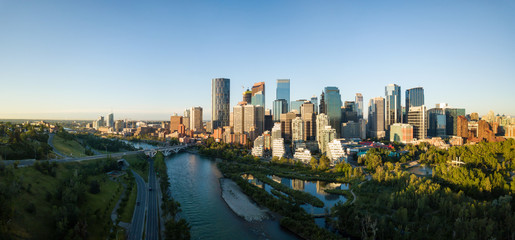 Aerial panoramic view of a beautiful modern cityscape during a vibrant sunny sunrise. Taken in...