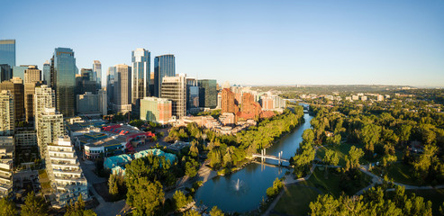 Aerial panoramic view of a beautiful modern cityscape during a vibrant sunny sunrise. Taken in...