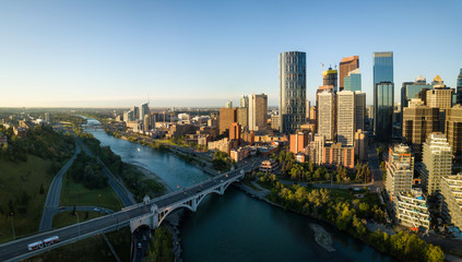 Aerial panoramic view of a beautiful modern cityscape during a vibrant sunny sunrise. Taken in Calgary Downtown, Alberta, Canada. - obrazy, fototapety, plakaty
