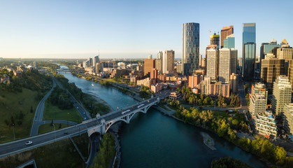 Aerial panoramic view of a beautiful modern cityscape during a vibrant sunny sunrise. Taken in Calgary Downtown, Alberta, Canada.