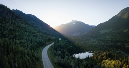 Striking aerial panoramic landscape view of a scenic road in the valley surrounded by the beautiful...