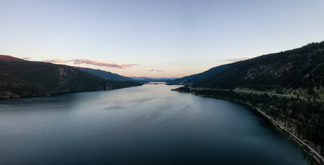 Aerial panoramic view of Kalamalka Lake during a vibrant summer sunset. Located near Kelowna and Vernon, BC, Canada.