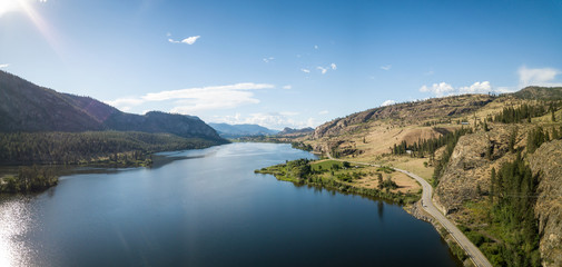 Aerial panoramic view of Okanagan Hwy near Vaseux Lake during a sunny summer day. Located between Oliver and Penticton, BC, Canada. - obrazy, fototapety, plakaty
