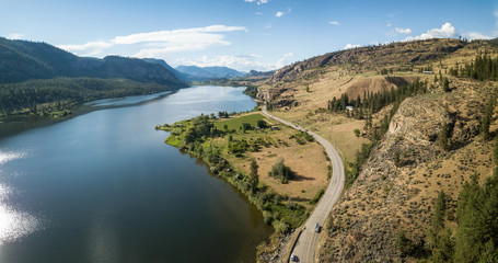 Aerial panoramic view of Okanagan Hwy near Vaseux Lake during a sunny summer day. Located between Oliver and Penticton, BC, Canada. - obrazy, fototapety, plakaty