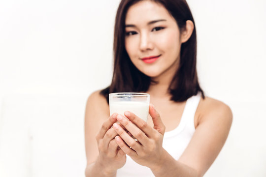 Woman hands holding glass of fresh milk