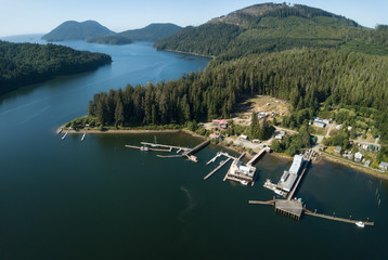 Aerial panoramic view of a little remote town, Winter Harbour, during a vibrant sunny summer day. Located in the Northern Vancouver Island, BC, Canada.