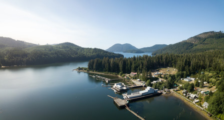 Aerial panoramic view of a little remote town, Winter Harbour, during a vibrant sunny summer day....
