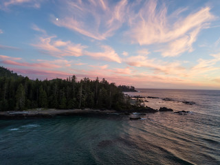 Aerial view of a beautiful beach on Pacific Ocean Coast druing a vibrant sunny summer sunset. Taken in Raft Cove Provincial Park, Nortern Vancouver Island, BC, Canada.