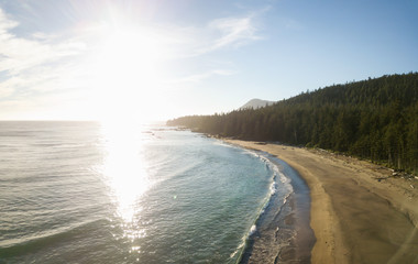 Aerial view of a beautiful beach on Pacific Ocean Coast druing a vibrant sunny summer sunset. Taken in Raft Cove Provincial Park, Nortern Vancouver Island, BC, Canada.