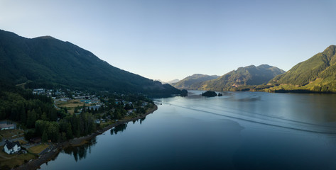 Fototapeta premium Aerial view of a small town, Port Alice, during a sunny summer sunrise. Located in Northern Vancouver Island, BC, Canada.