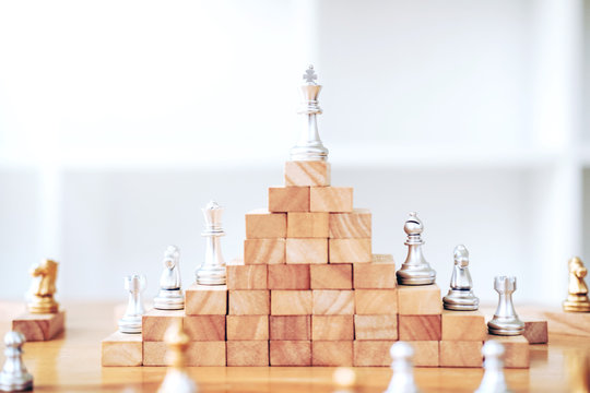 Business leadership concept,chess game on wood game business strategy leader for success
