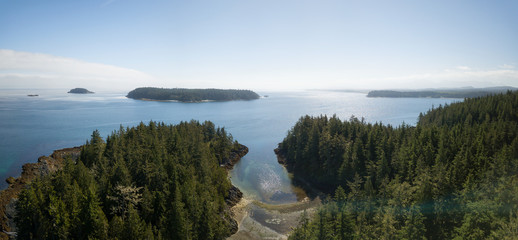 Aerial panoramic landscape of a rocky coast during a vibrant summer day. Taken on the Northern Vancouver Island, British Columbia, Canada.