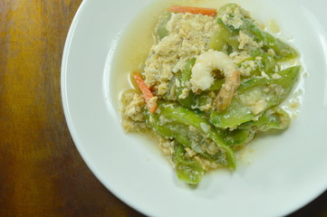 stir fried angled gourd with egg topping shrimp on dish