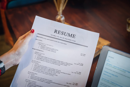 woman holding resume application with using tablet digital to job search on internet. applying for a job concept.