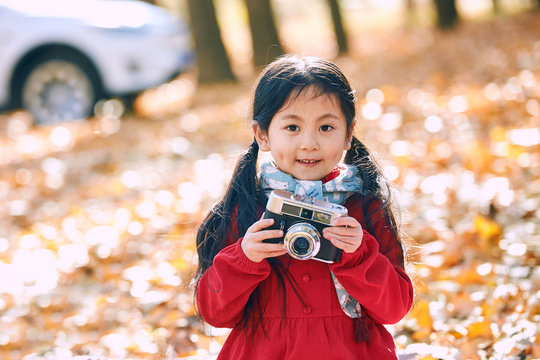 Lovely little girl with a camera