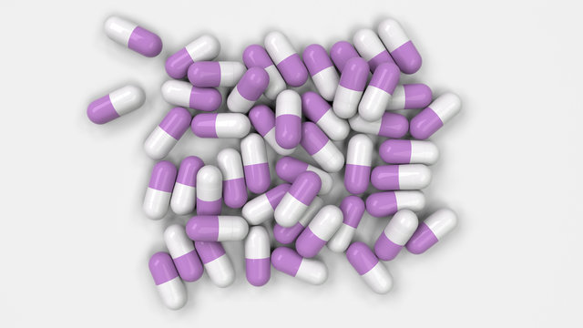 Pile of white and purple medicine capsules