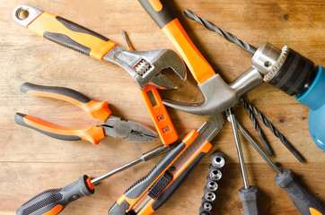 Set of tools on wooden background.