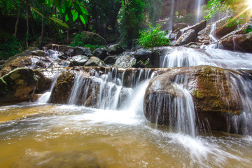 Fototapeta premium Beautiful waterfalls flow through the rocks in forest at Soo Da Cave Roi et Thailand