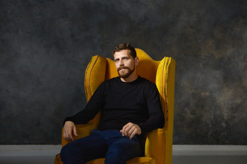 Isolated portrait of good looking elegant young European male with fuzzy trimmed beard and mustache...