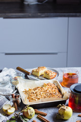Homemade Food Bakery Concept. Pies with apples and almond flakes. Norwegian Biscuit Pie on stone concrete table background. Scandinavia Kitchen