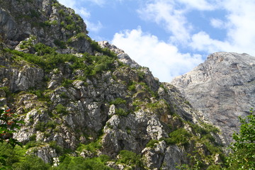 natural landscape photo of pretty mountain passage landscape with light blue sky