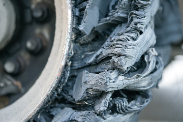 Destroyed blown tire with crushed and damaged rubber on a truck.