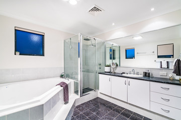 Large clean bathroom with bathtub and luxury fittings.