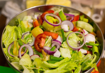 fresh lunch salad ring red onion lettuce tomatoes in a metal full bowl closeup useful snack diet