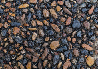 stone canvas smooth oval stones brown gray stones mini on black background basalt sand close-up pattern hard weathered surface