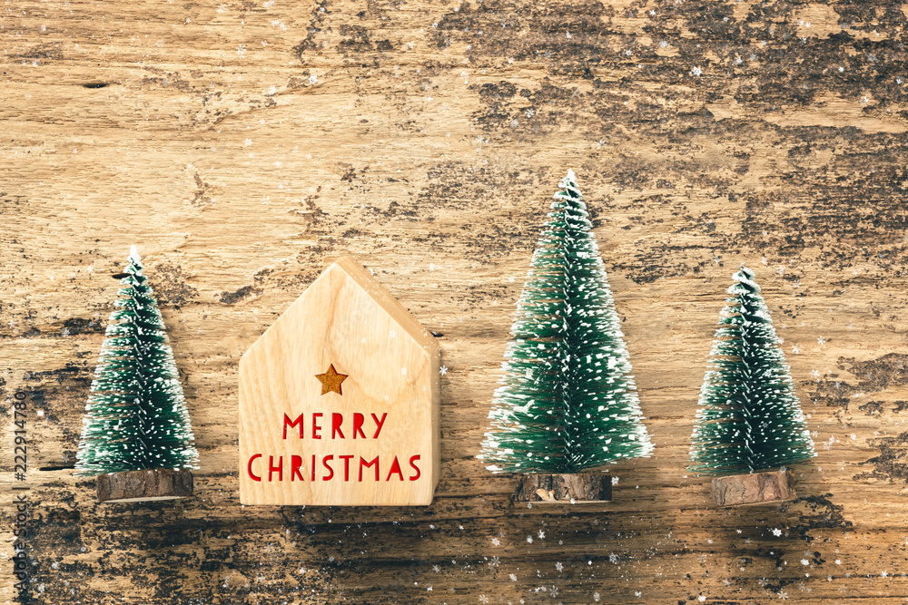 Aufkleber top view of handwriting red merry christmas on home toy with mini christmas tree wood on rustic wood