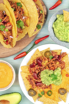 An overhead photo of Mexican tacos and nachos with chili con carne and guacamole