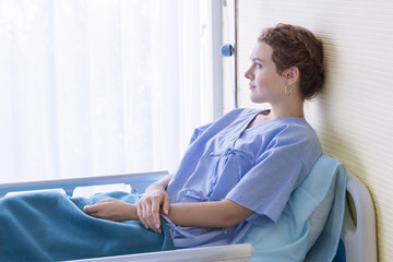 Attractive young woman patient thinking and dream about life on hospital bed.Copy space.