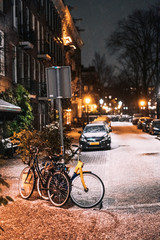 Bicycles parked along the road, night